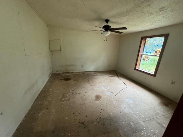 spare room featuring a textured ceiling and ceiling fan