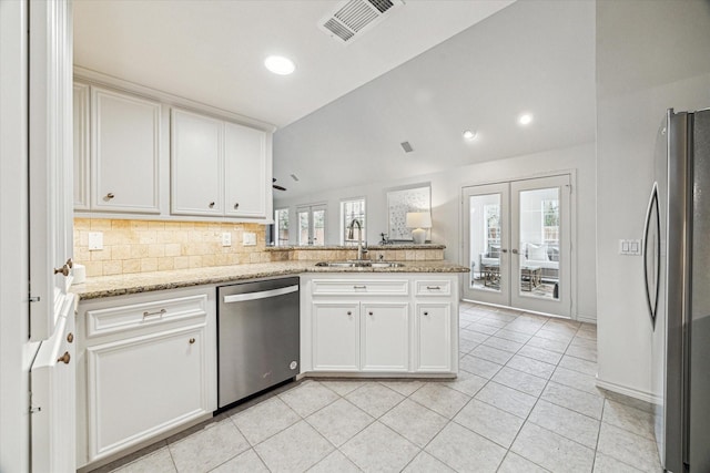 kitchen featuring visible vents, appliances with stainless steel finishes, a peninsula, french doors, and a sink