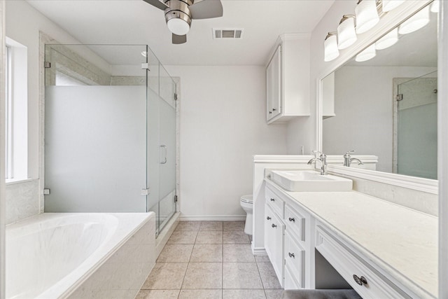 full bath with visible vents, toilet, a stall shower, a bath, and vanity