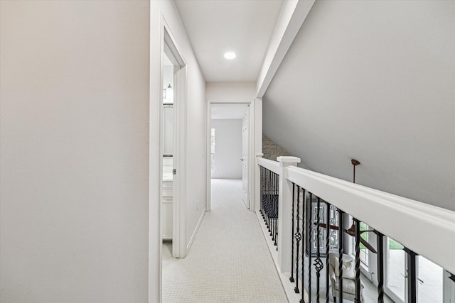 hall featuring baseboards and carpet floors