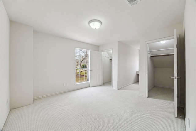 unfurnished bedroom featuring baseboards, visible vents, and carpet