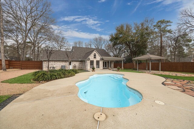 view of swimming pool featuring a gazebo, a fenced backyard, a fenced in pool, and a patio