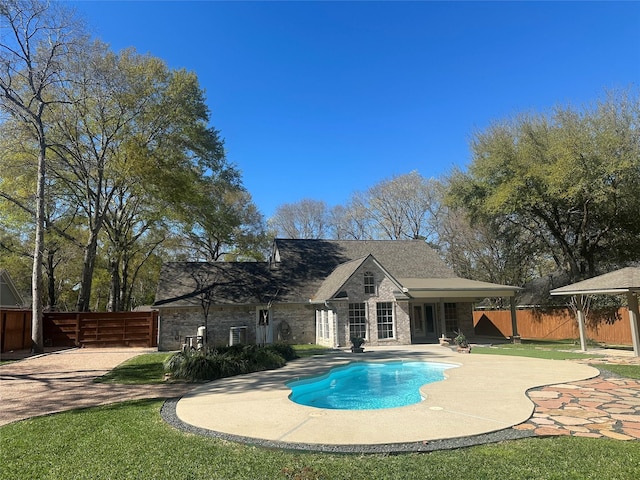 view of swimming pool with a fenced in pool, a patio, and fence