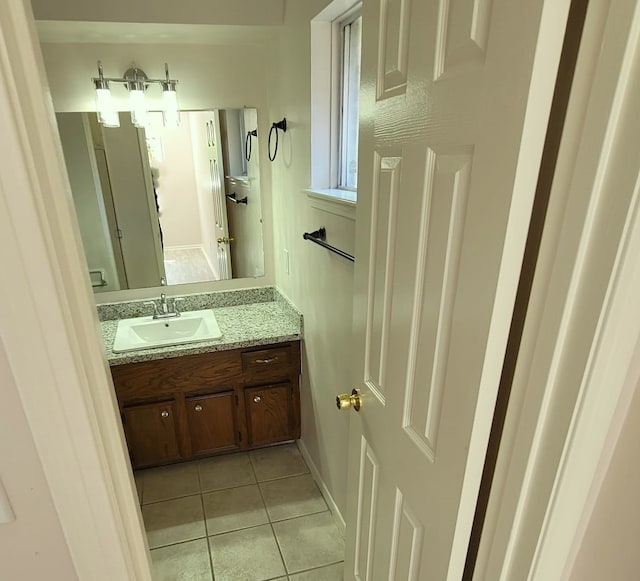 bathroom featuring tile patterned flooring and vanity