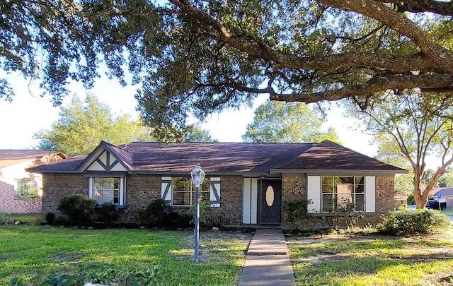 ranch-style home with a front lawn and brick siding