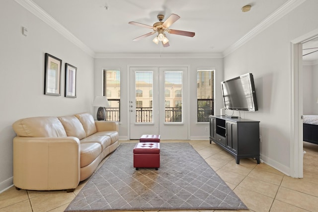 living area with baseboards, a ceiling fan, crown molding, and light tile patterned flooring