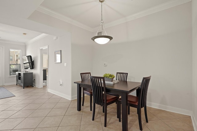 dining area featuring light tile patterned floors, baseboards, and ornamental molding