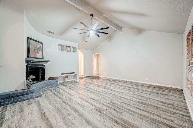 living room with arched walkways, visible vents, lofted ceiling with beams, a ceiling fan, and wood finished floors