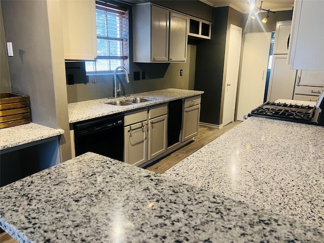 kitchen with black dishwasher, stove, ornamental molding, light stone countertops, and a sink