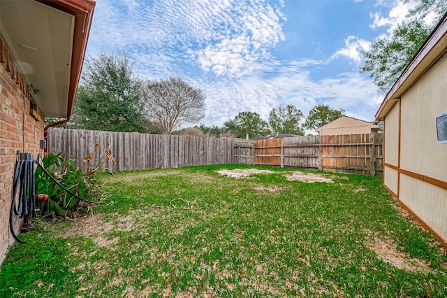 view of yard with a fenced backyard