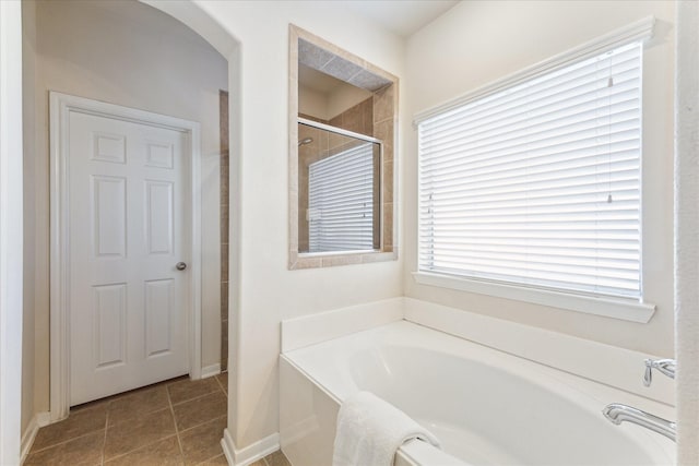 full bath featuring a tile shower, a bath, and tile patterned floors