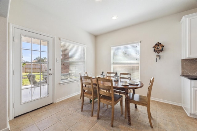 dining area featuring light tile patterned floors, recessed lighting, and baseboards