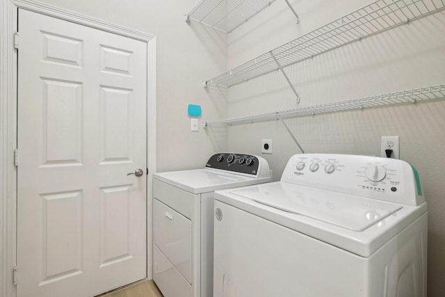 washroom featuring laundry area and washer and dryer