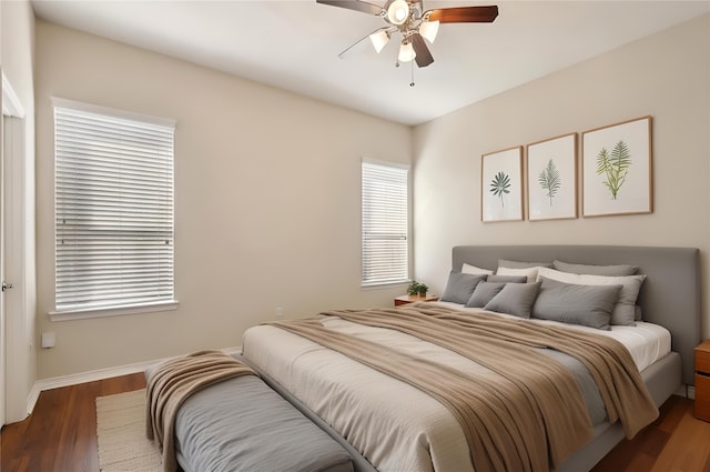 bedroom with ceiling fan, baseboards, and wood finished floors