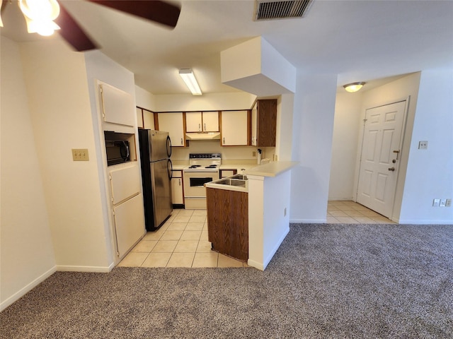 kitchen with visible vents, white electric range, freestanding refrigerator, light carpet, and black microwave