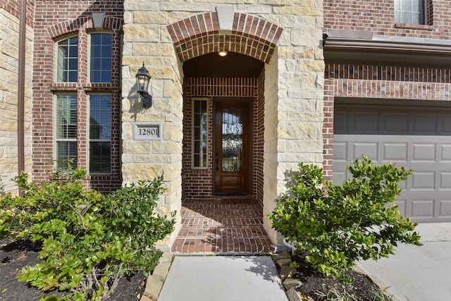 entrance to property featuring stone siding and brick siding