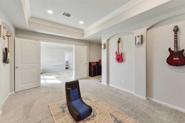 corridor featuring carpet floors, a tray ceiling, visible vents, ornamental molding, and baseboards