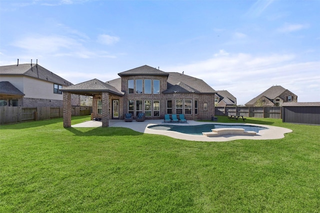 rear view of property with a patio area, a fenced backyard, and brick siding