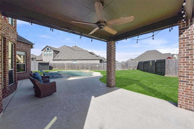 view of patio featuring a storage shed, a fenced backyard, a residential view, ceiling fan, and an outbuilding