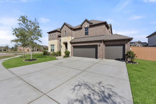 french country style house featuring a garage, concrete driveway, a front lawn, and fence