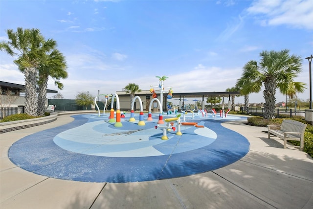 view of home's community featuring playground community and fence