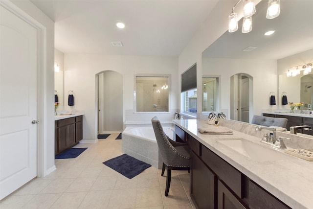 full bathroom with recessed lighting, two vanities, a sink, a bath, and tile patterned floors