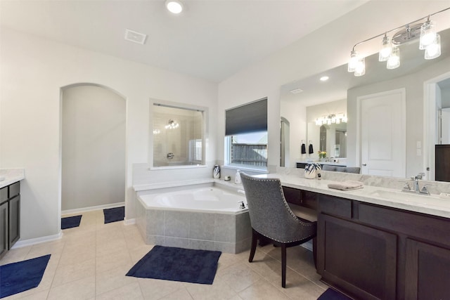 full bathroom featuring vanity, a garden tub, visible vents, and tile patterned floors