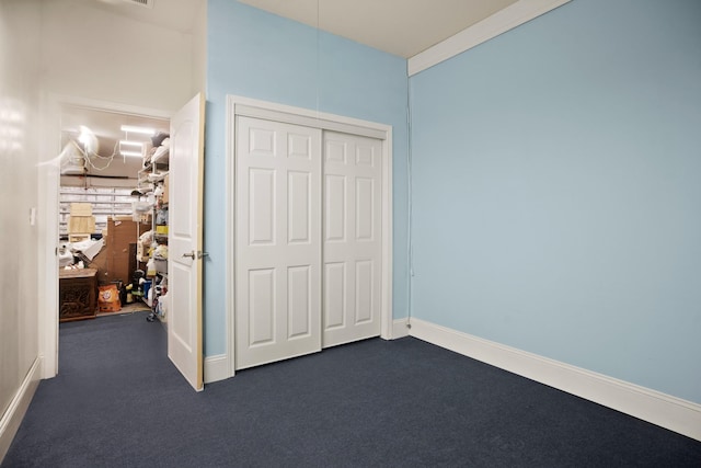 unfurnished bedroom featuring a closet, carpet, and baseboards