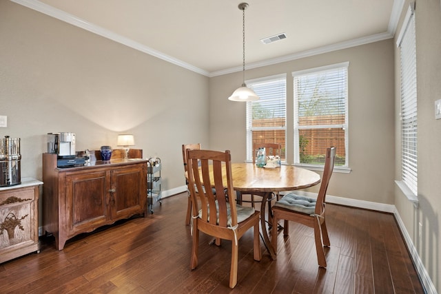 dining area featuring dark wood-style floors, visible vents, ornamental molding, and baseboards