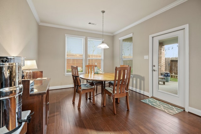 dining area with dark wood-style flooring, visible vents, crown molding, and baseboards