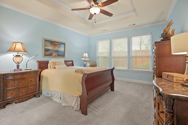 bedroom featuring crown molding, a raised ceiling, visible vents, light carpet, and baseboards