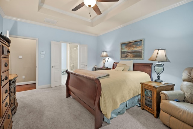 bedroom featuring light carpet, baseboards, a raised ceiling, ceiling fan, and crown molding