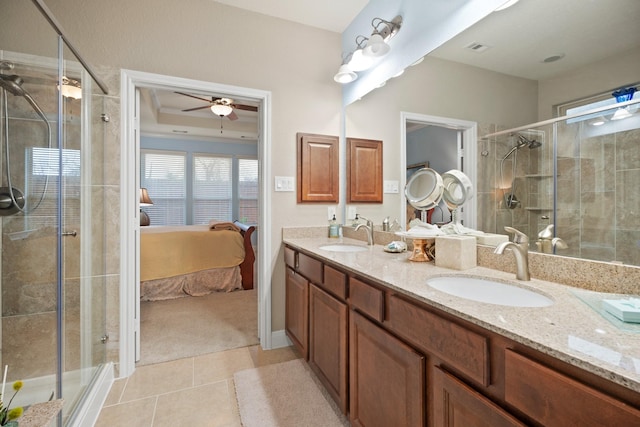 bathroom with connected bathroom, a stall shower, a sink, and tile patterned floors