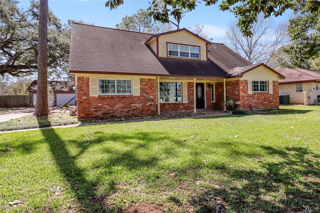 view of front of property with central AC, brick siding, a front lawn, and a shingled roof