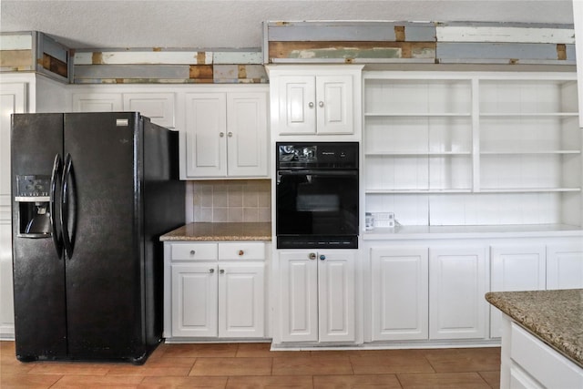 kitchen featuring open shelves, black appliances, white cabinetry, and decorative backsplash