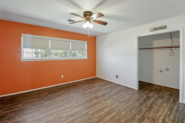 unfurnished bedroom with baseboards, a closet, visible vents, and wood finished floors