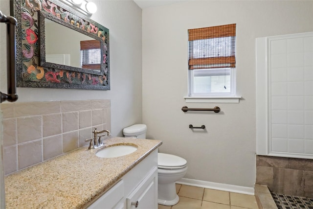 bathroom with toilet, tile patterned flooring, baseboards, and vanity