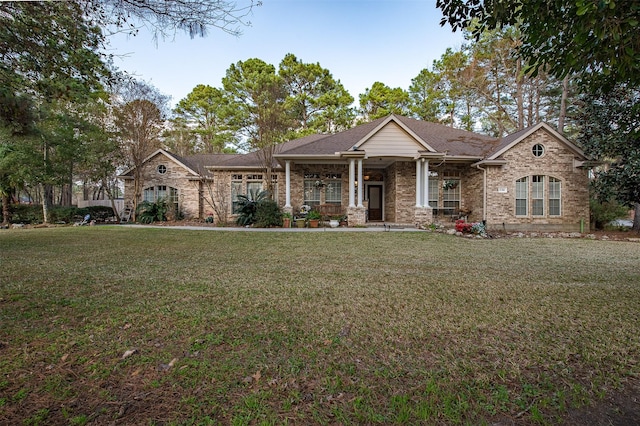 view of front of house with a front lawn and brick siding