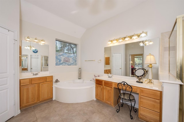 bathroom with lofted ceiling, a garden tub, tile patterned flooring, a sink, and two vanities