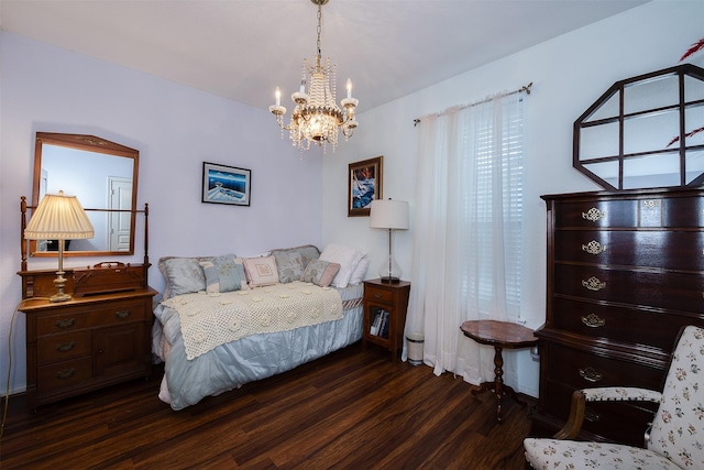 bedroom with wood finished floors and a notable chandelier