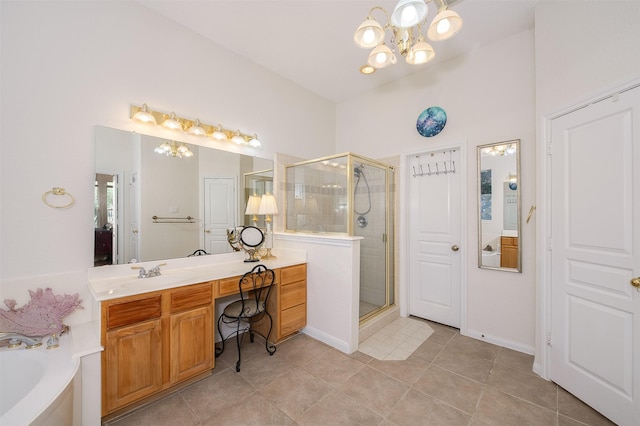 bathroom featuring a chandelier, a stall shower, tile patterned flooring, and vanity