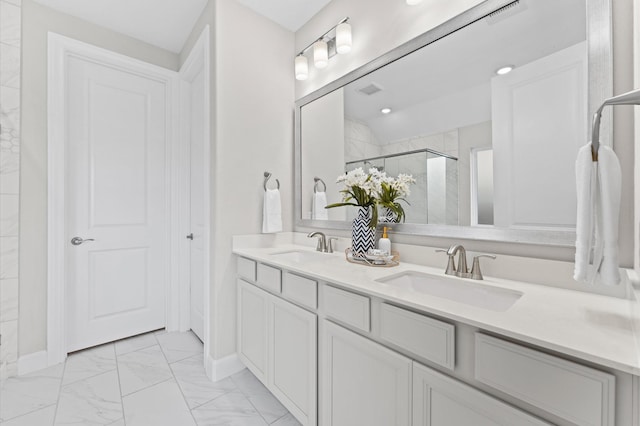 full bathroom with marble finish floor, double vanity, a sink, and a shower stall