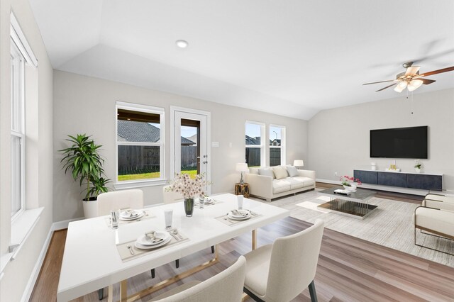 interior space featuring lofted ceiling, recessed lighting, ceiling fan, wood finished floors, and baseboards