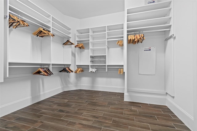 walk in closet with wood finish floors