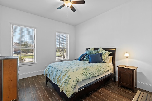 bedroom featuring ceiling fan, wood finish floors, and baseboards