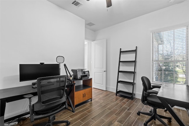 home office featuring ceiling fan, visible vents, baseboards, and wood finish floors