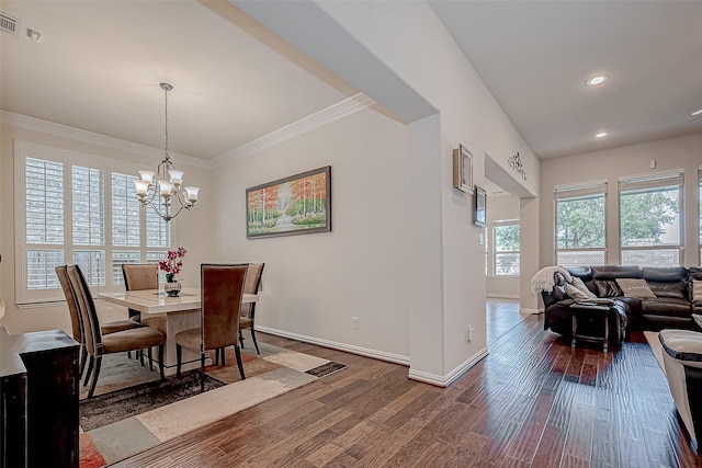 dining room with a notable chandelier, recessed lighting, ornamental molding, wood finished floors, and baseboards