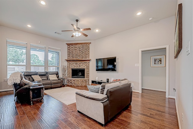 living room featuring visible vents, a ceiling fan, wood finished floors, a fireplace, and recessed lighting