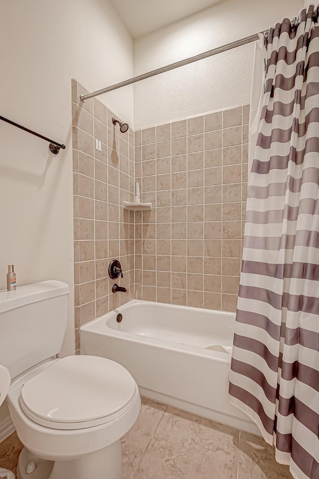 bathroom with toilet, shower / bath combo, and tile patterned floors