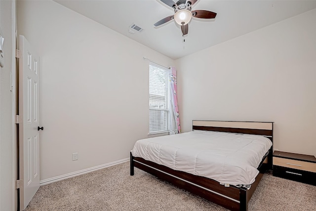 carpeted bedroom featuring baseboards, visible vents, and a ceiling fan